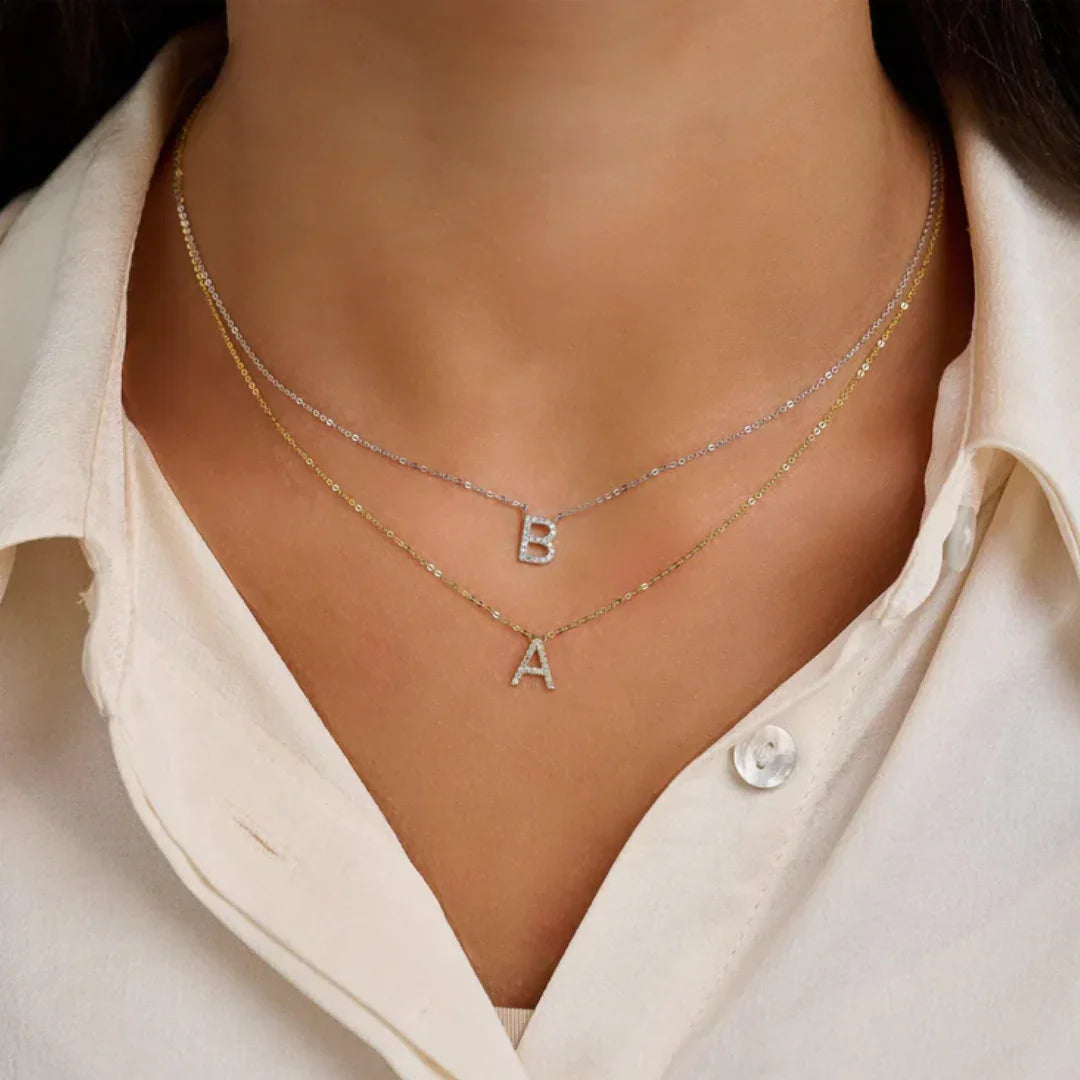 'B and A' Letter Initial Necklace on a person wearing a white shirt.
