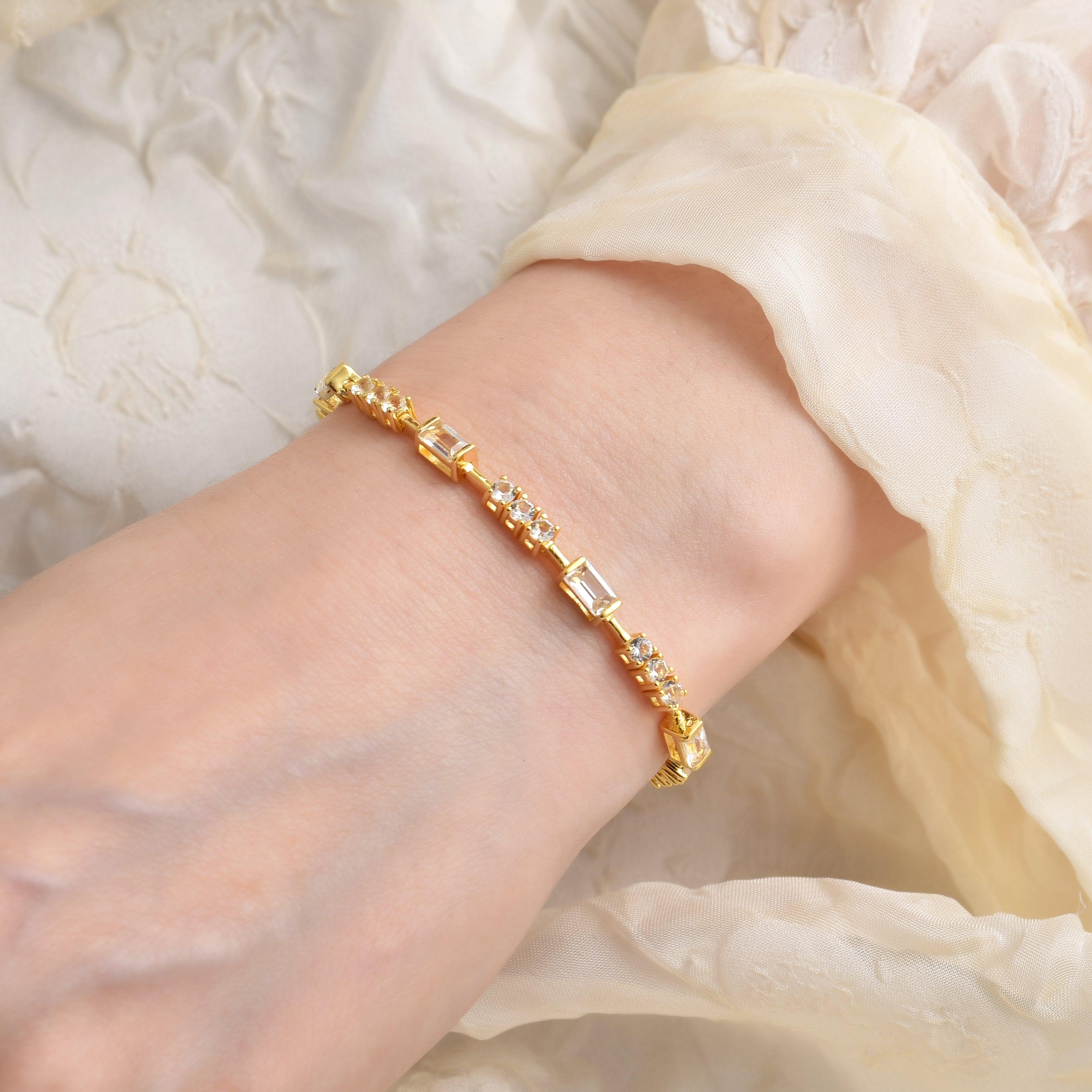 Elegant model hand showcasing the intricate details of our White Topaz Baguette Bracelet 14k Yellow Gold Plated Dainty Bracelet Bridesmaid Gift Bridal Shower Silver Bracelet Gift for Her