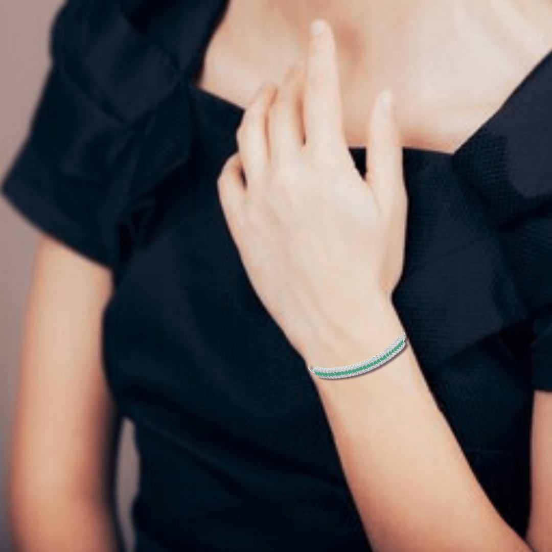 Elegant model hand showcasing the intricate details of our Emerald Gemstone Cuff Bracelet Emerald Silver Bracelet