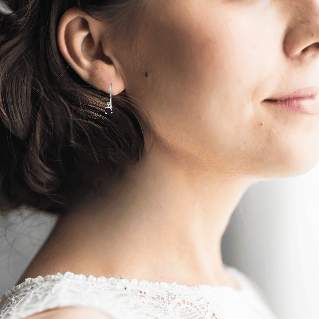 model showcasing Blue Sapphire Hoop Earrings Rhodium Plated Silver Earrings
