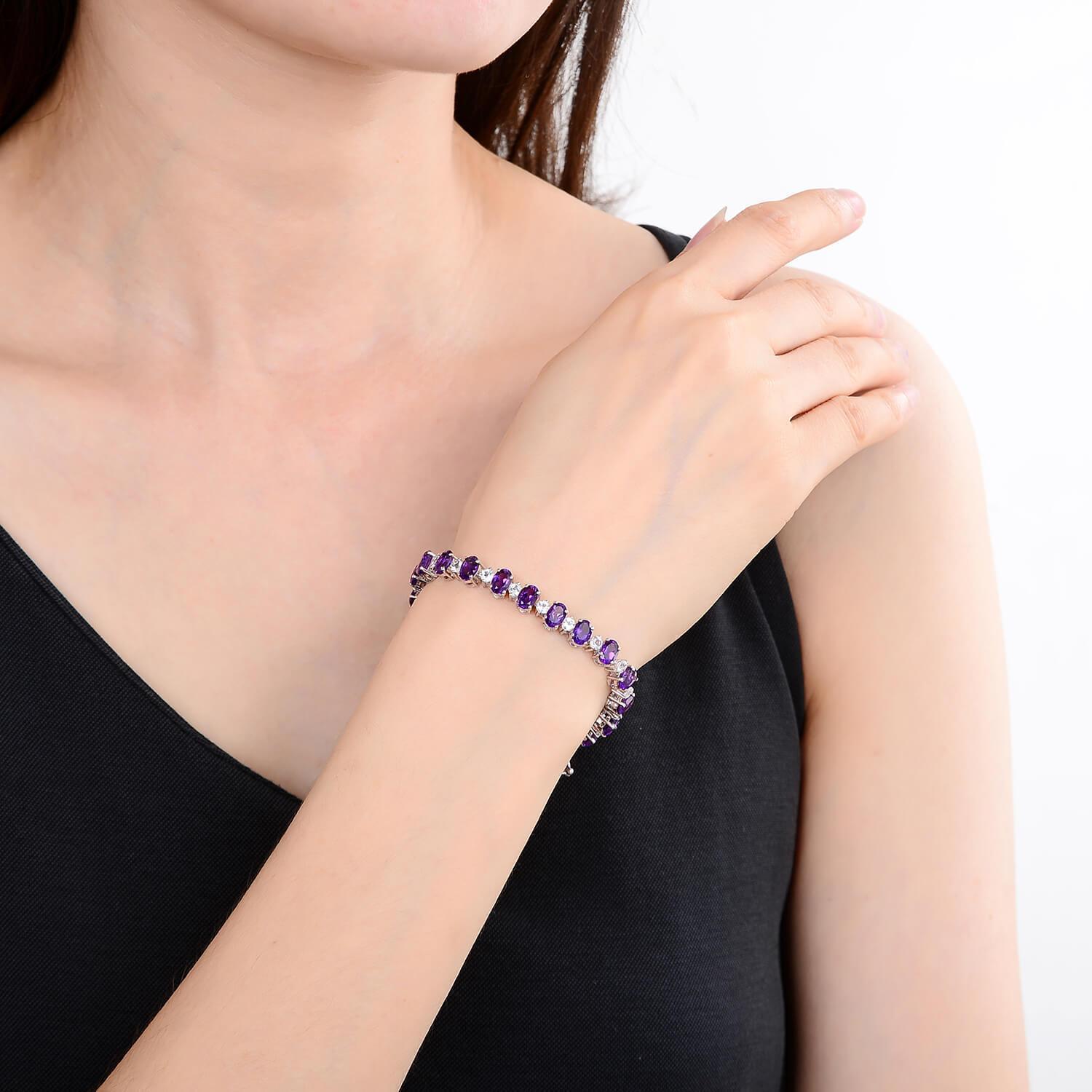 hand showcasing the Sterling Silver Amethyst Bracelet, $ 200 - 300, Amethyst, Oval, Purple, 925 Sterling Silver, Tennis