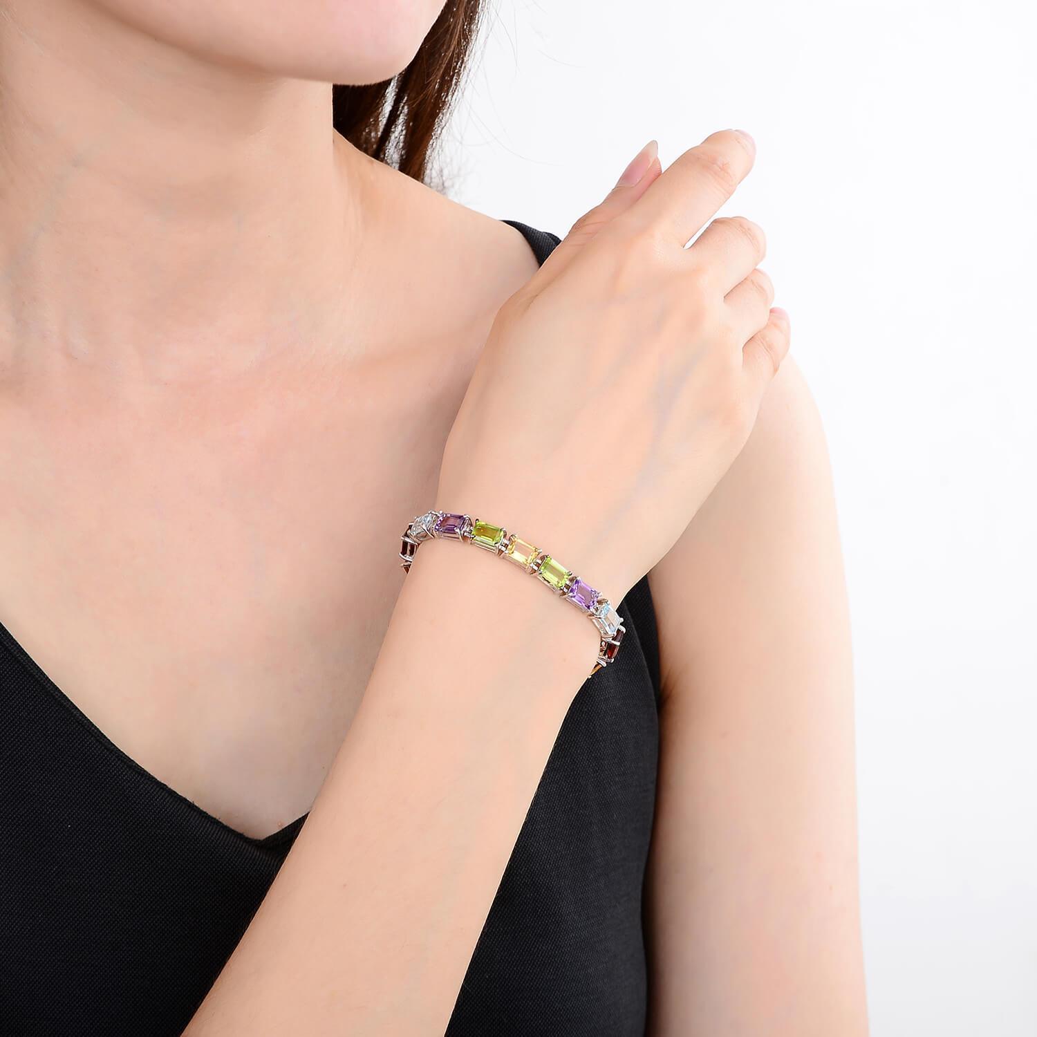 Elegant model hand showcasing the intricate details of our silver bracelet Multi Color Sterling Silver Bracelet, $ 150 - 200, $ 200 - 300, Octagon, Blue, Purple, Green, Yellow, 925 Sterling Silver, Tennis