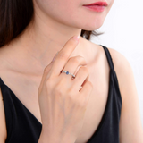 Model in blue sapphire ring, model in three stone ring, model wearing blue sapphire stone ring