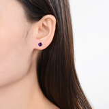 Model showcasing amethyst solitary earrings