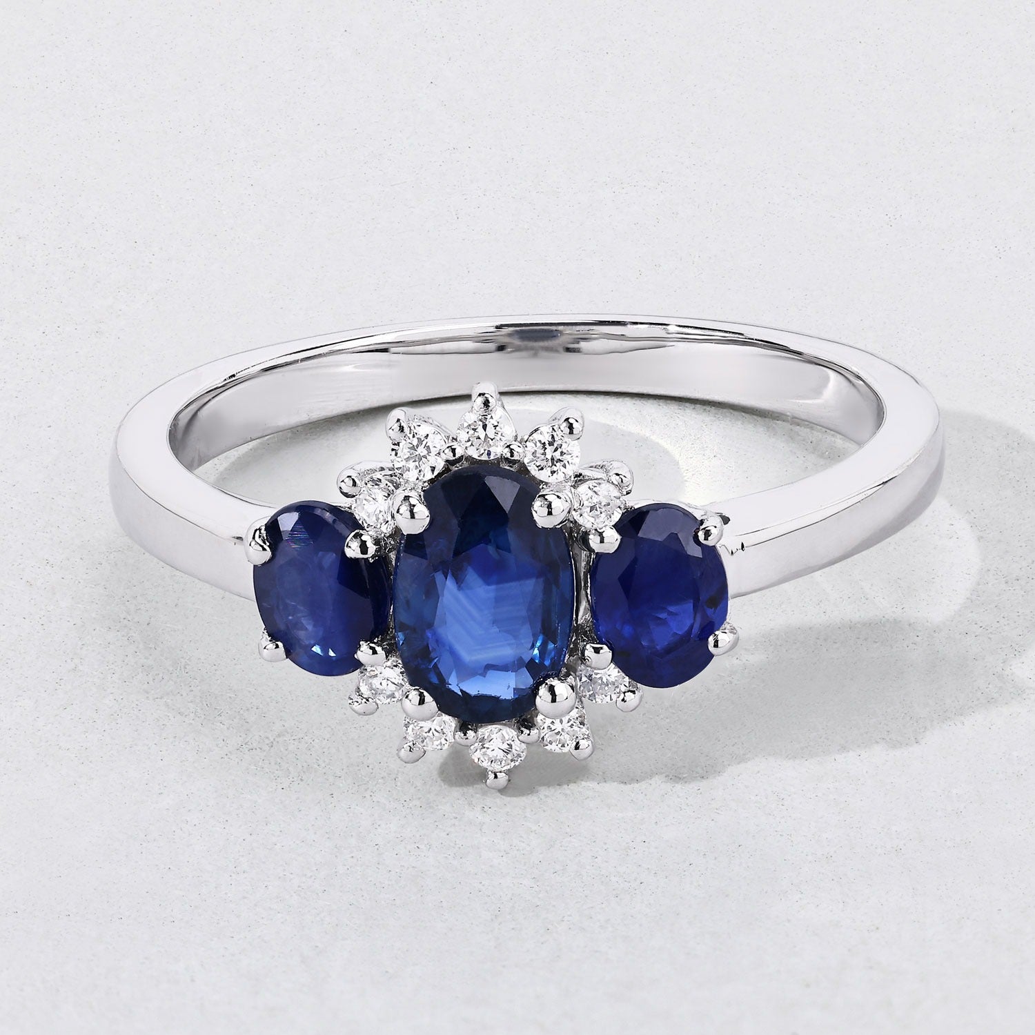 0.99 Ct Oval Blue Sapphire and Lab Diamond Prong Silver Three Stone Cocktail Ring