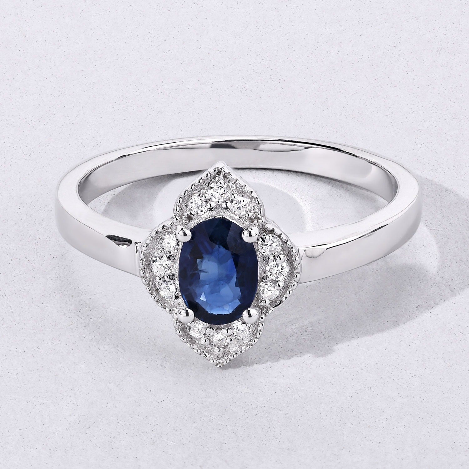 0.55 Ct Oval Blue Sapphire and Lab Diamond Silver Prong Floral Halo Ring