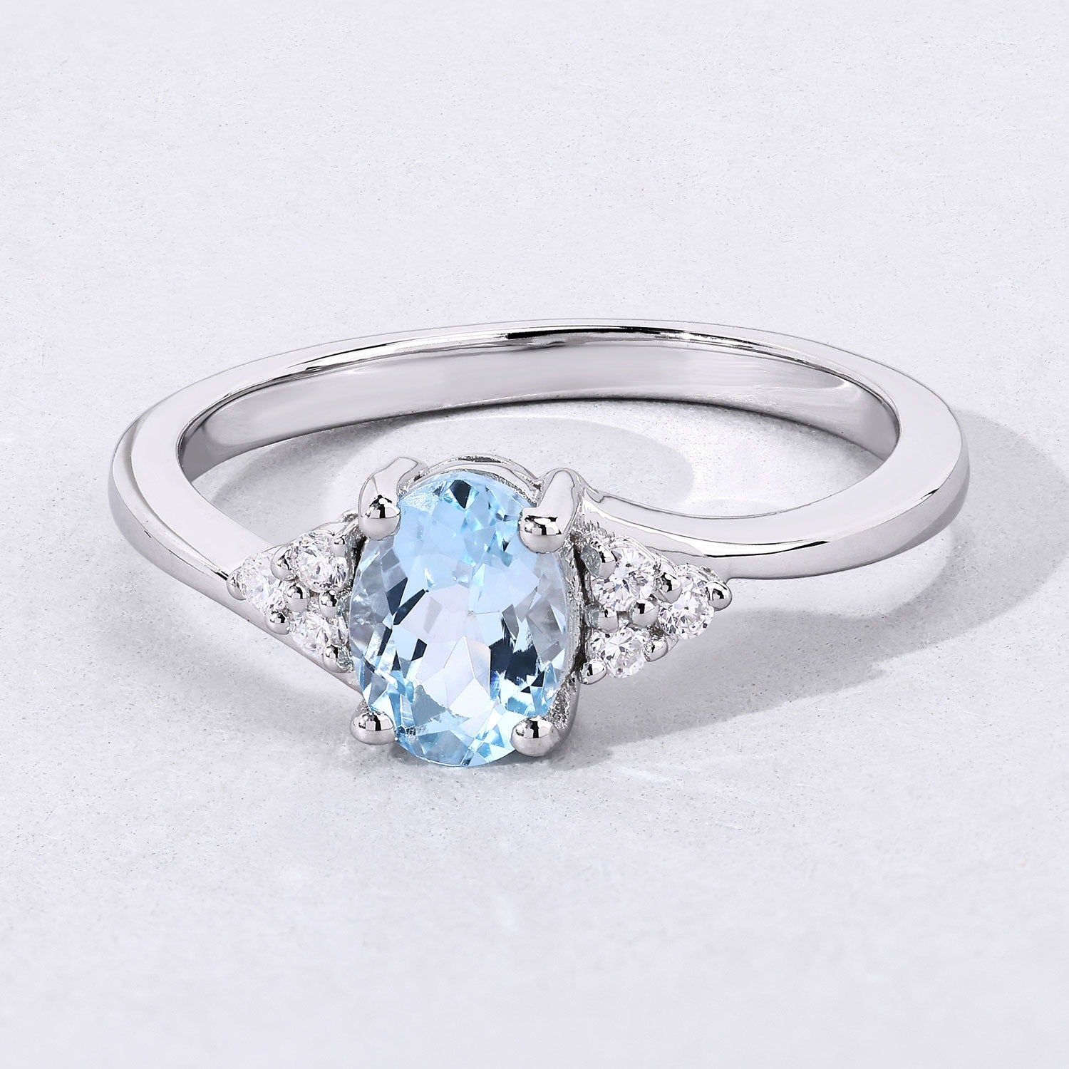 0.60 Ct Oval Blue Aquamarine and Lab Diamond Prong Sterling Silver Bypass Ring