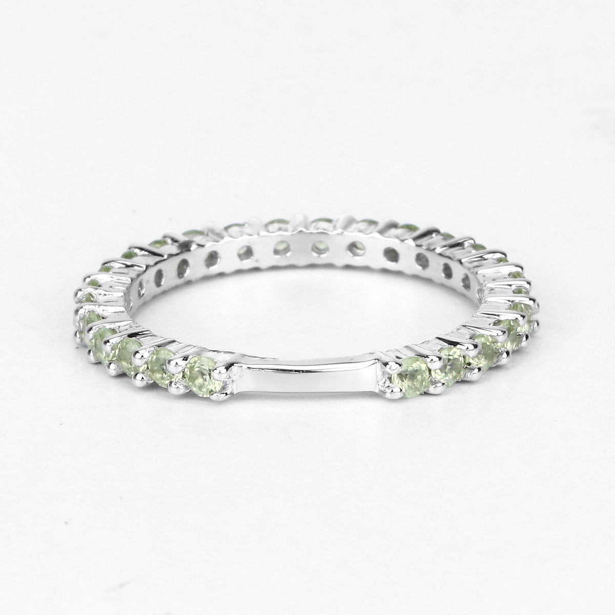 0.91 Ct Round Light Green Peridot Rhodium Over 925 Sterling Silver Eternity Band Ring
