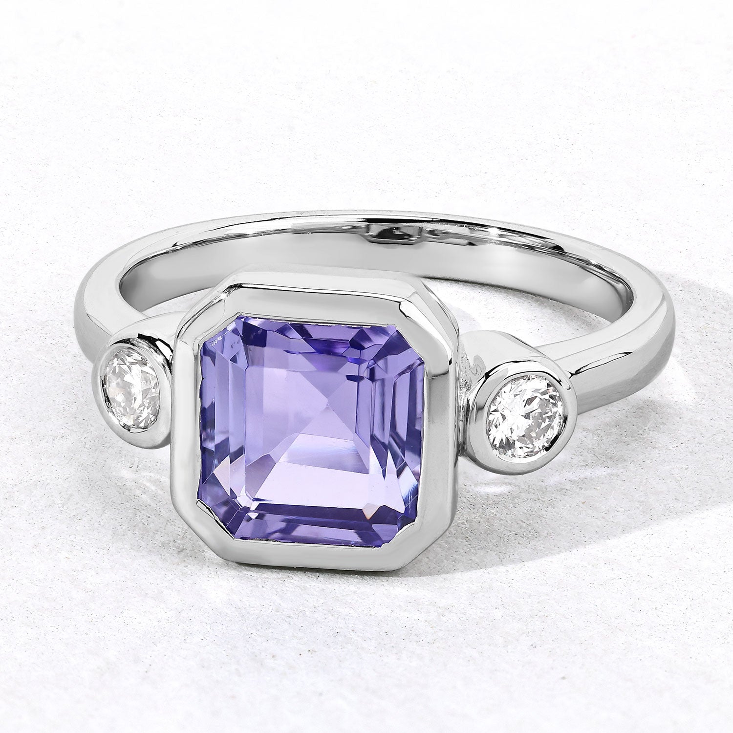 3.49 Cttw Octagon Violet Tanzanite and Lab Diamond Bezel Rhodium over Silver 3-Stone Ring